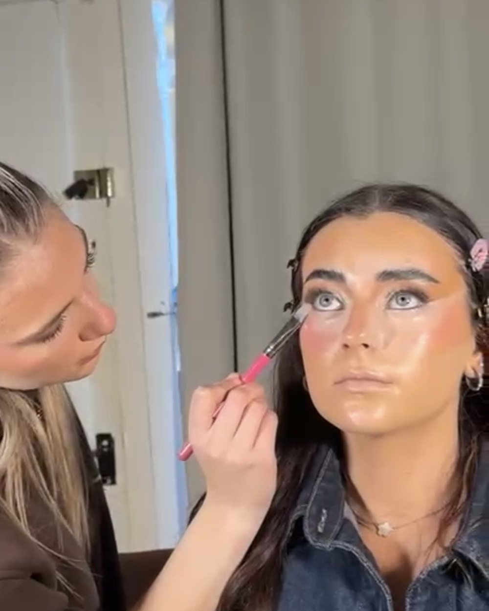 Kali applying makeup for a client, MADE by Kali in Wrexham